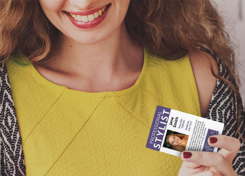 Online professional stylist course student holding an ID